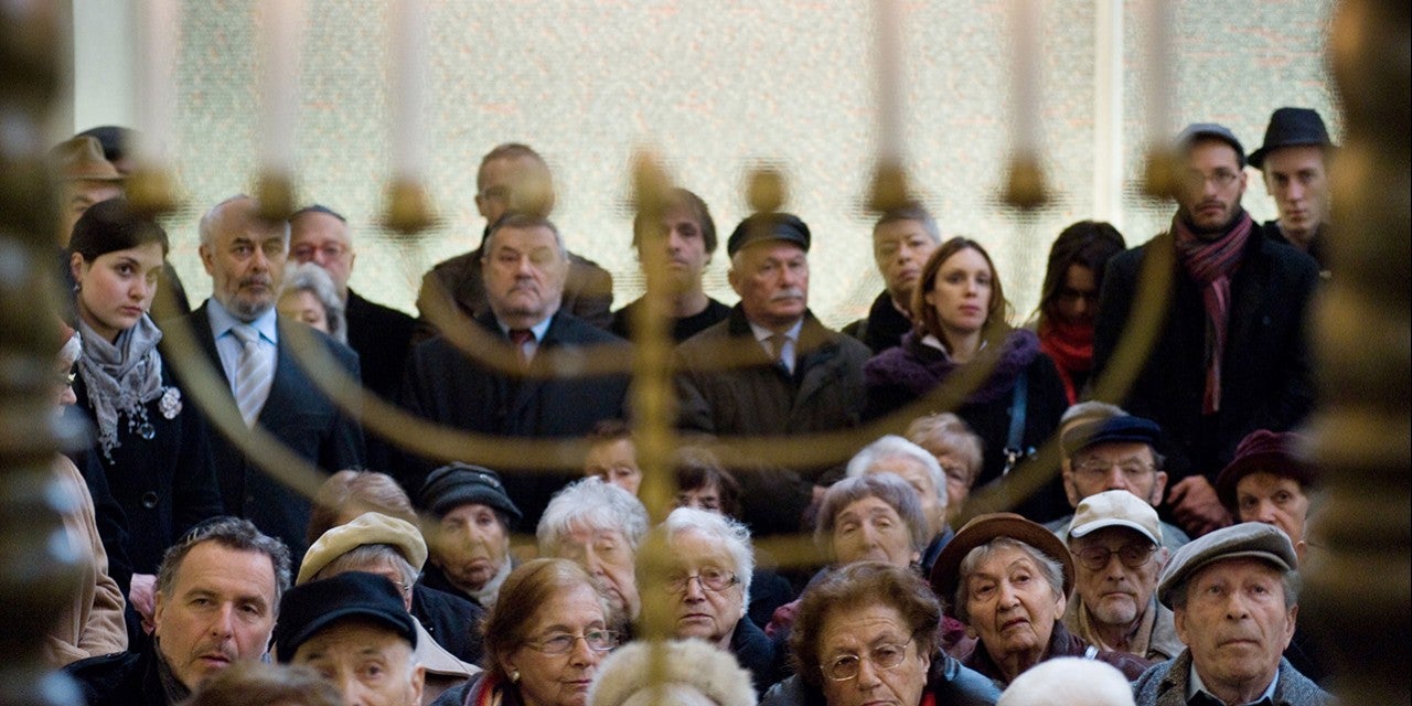 Photo of Polish Jews looking at a menorah 