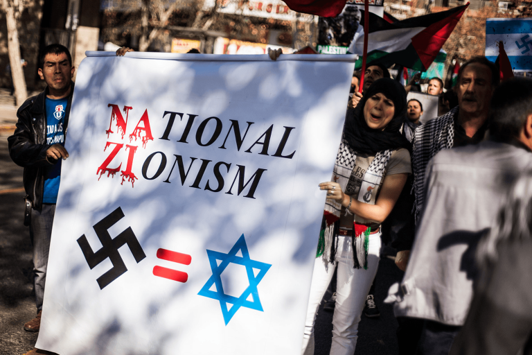 Photo saying National Zionism with a swastika equal sign and Star of David