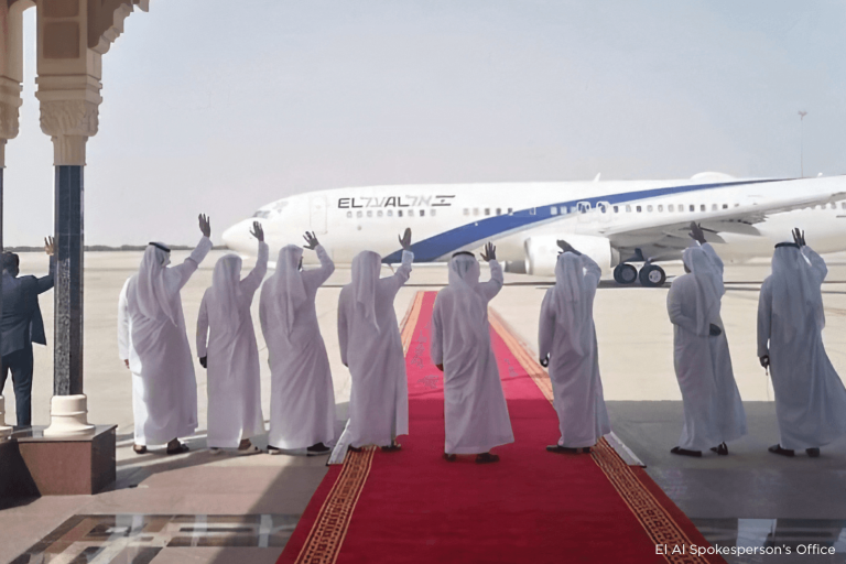 Emirati officials waving at an El Al plane in Abu Dhabi