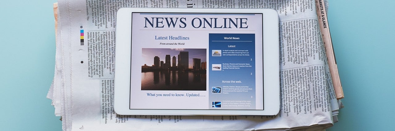 Photo of a stack of newspapers and an iPad displaying - News Online