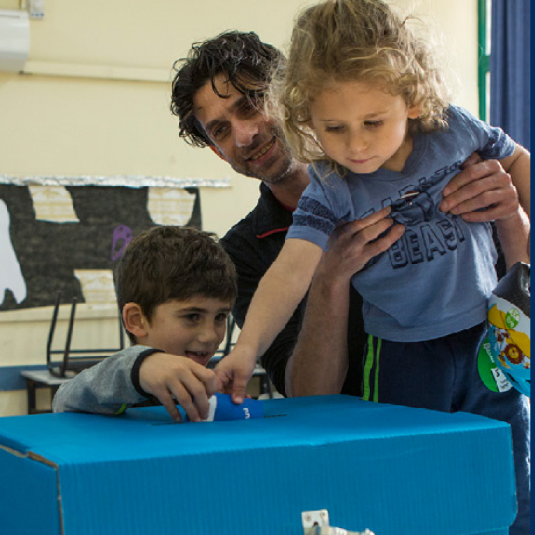 Father and children cast his vote in Israeli election