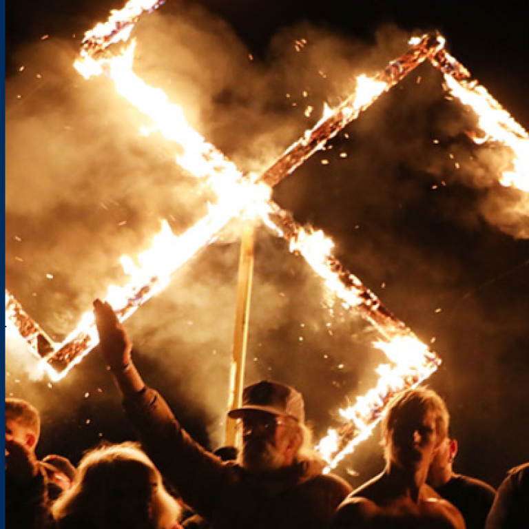 Far-right rally with flaming swastika