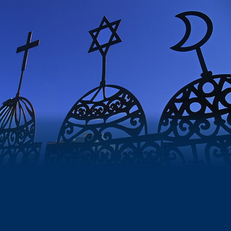 Photo of three religious symbols - a Cross, Jewish Star, and crescent moon.