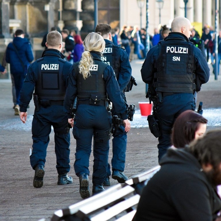 Photo of the backs of four German polizei