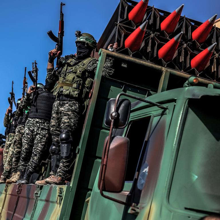 Members of Hamas display rockets during a military parade