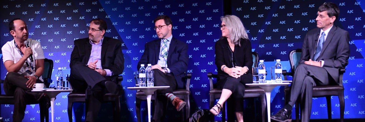 Photo of a panel of 4 experts, moderated by Yoav Limor, at AJC Global Forum 2018
