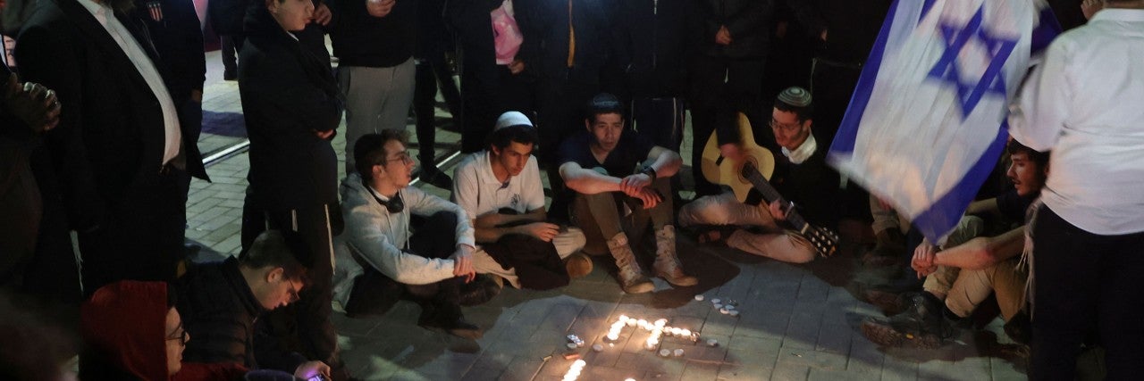 Israelis gather to mourn the deaths of seven worshippers in Jerusalem