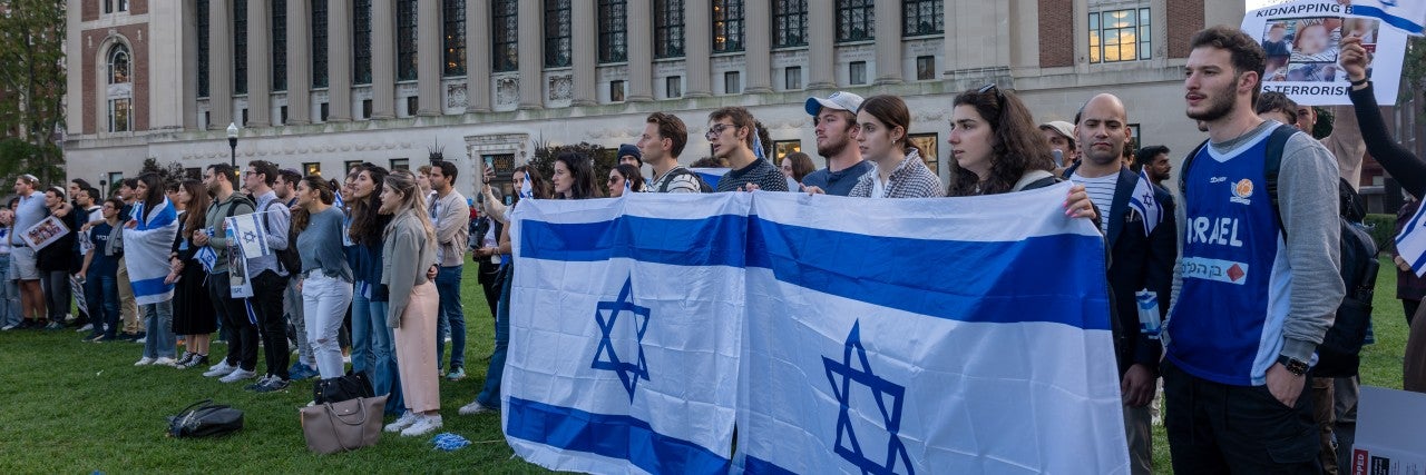 students on campus holding Israeli flags