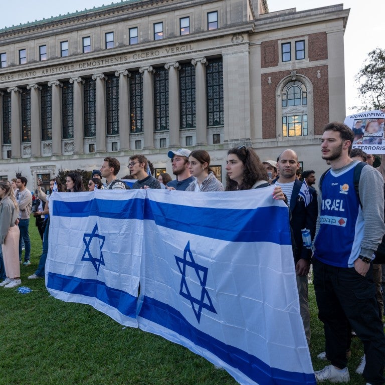 students on campus holding Israeli flags