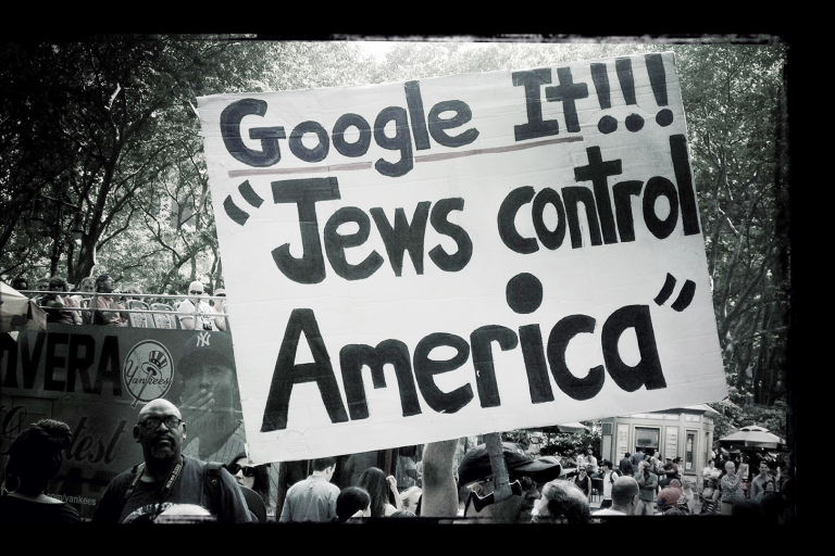 Black and White photo of a sign saying "Google it!! Jews control America"