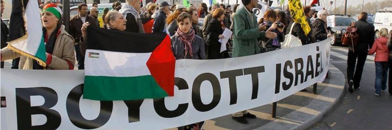 Photo of a BDS march with a large Boycott Israel banner