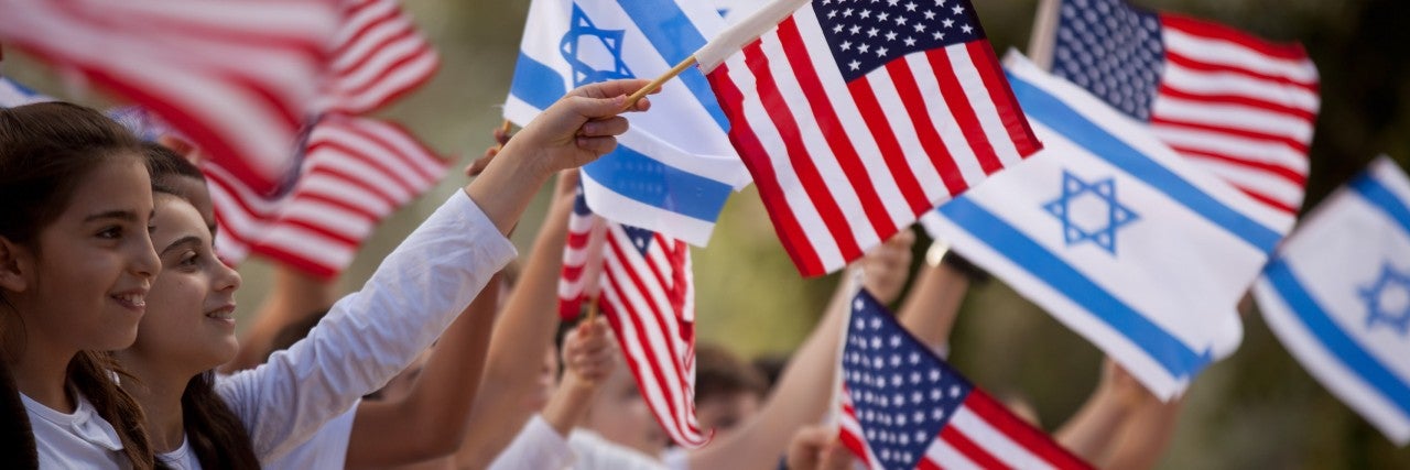 Photo of children waving Israeli and American flags