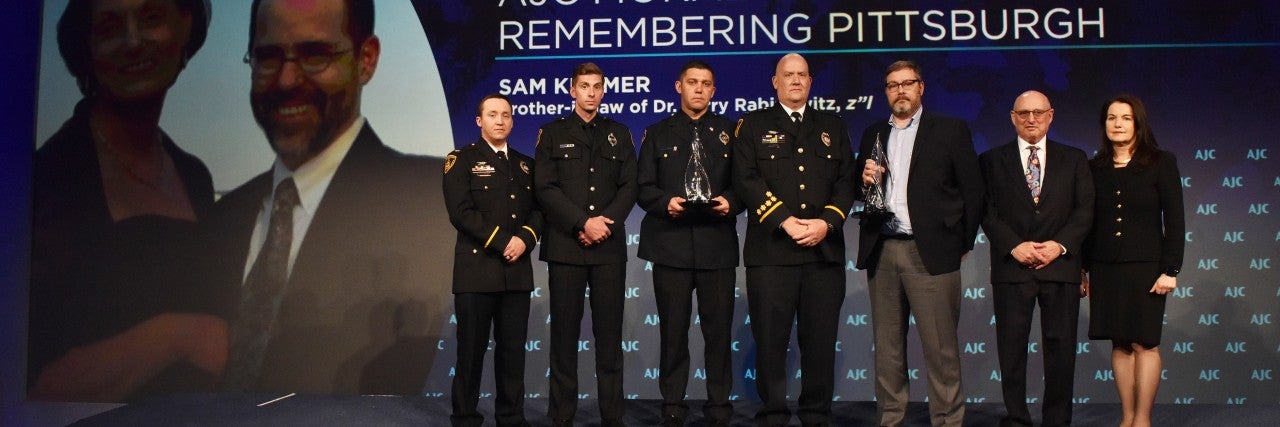 Photo of Pittsburgh First Responders accepting AJC Moral Courage Award at AJC Global Forum 2019