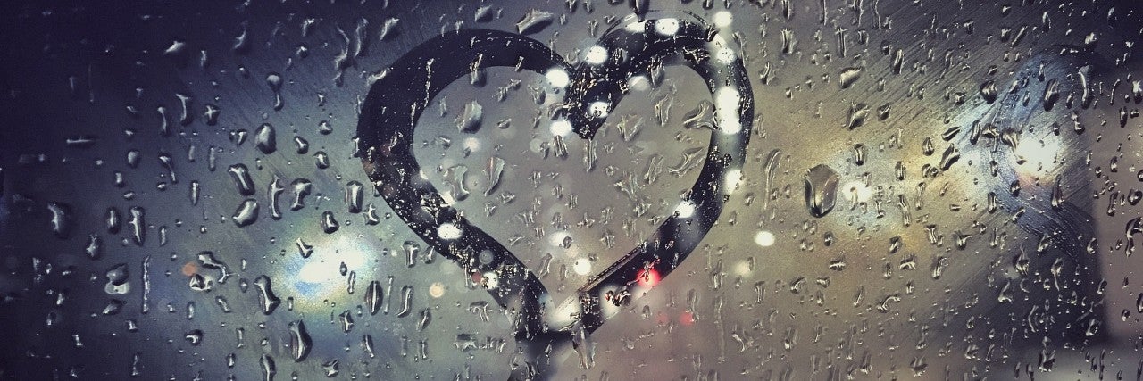 Photo of a heart outline on a window.