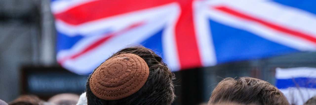 Man wearing kippah and British Jack flag