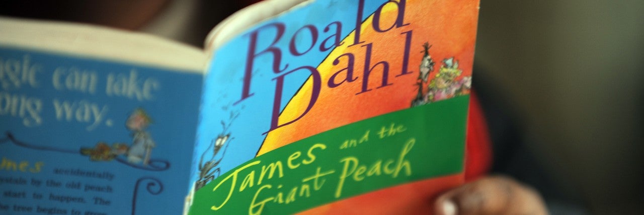 A child reads Roald Dahl's James and the Giant Peach