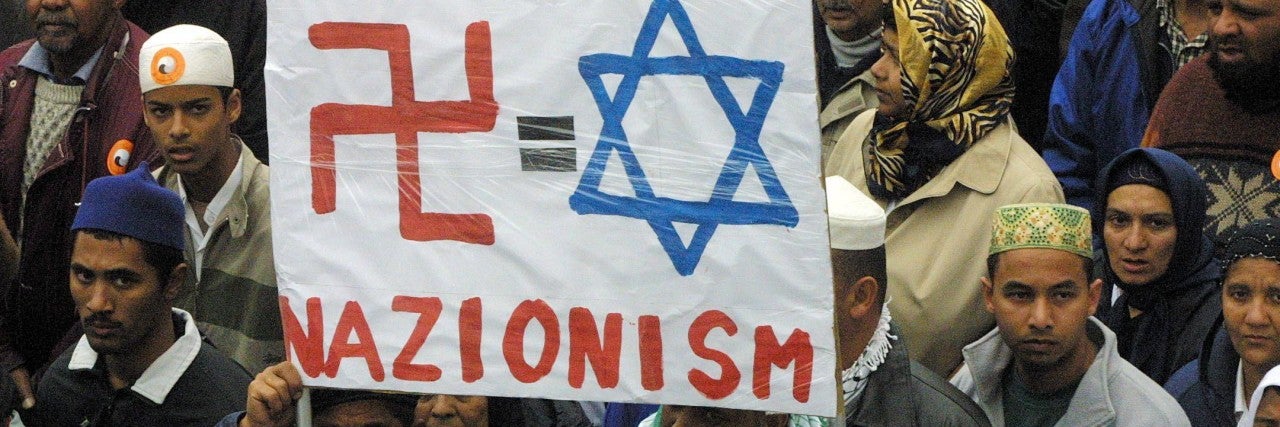 Sign with swastika and Jewish star outside of 2001 Durban Conference