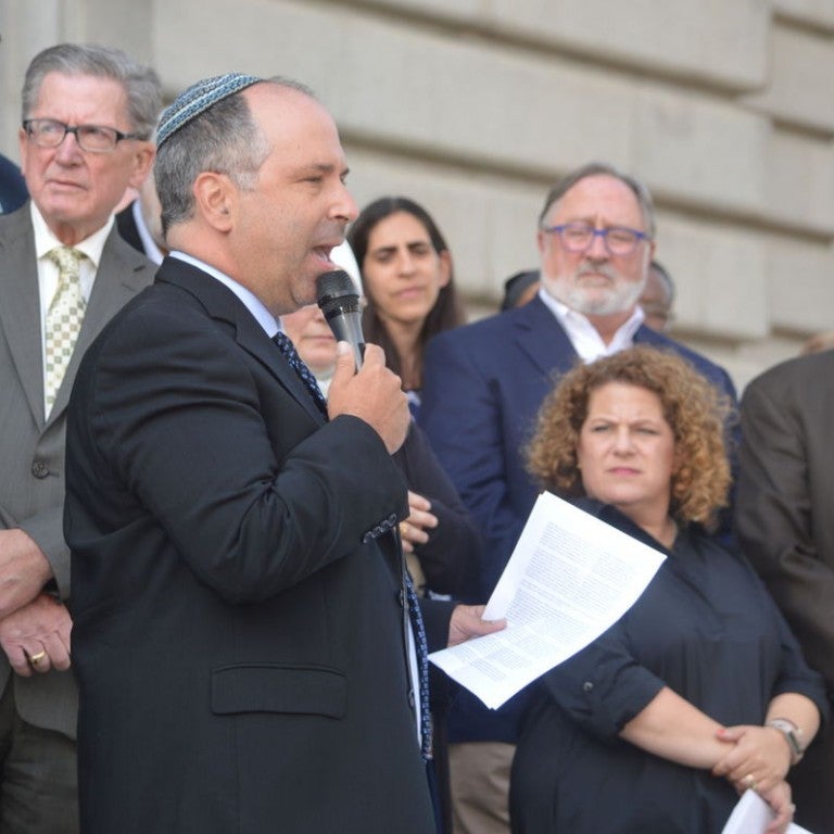 Photo of Rabbi Robert A. Nosanchuk of Anshe Chesed Fairmount Temple in Beachwod speaking to a crowd from the steps of Cleveland City Hall