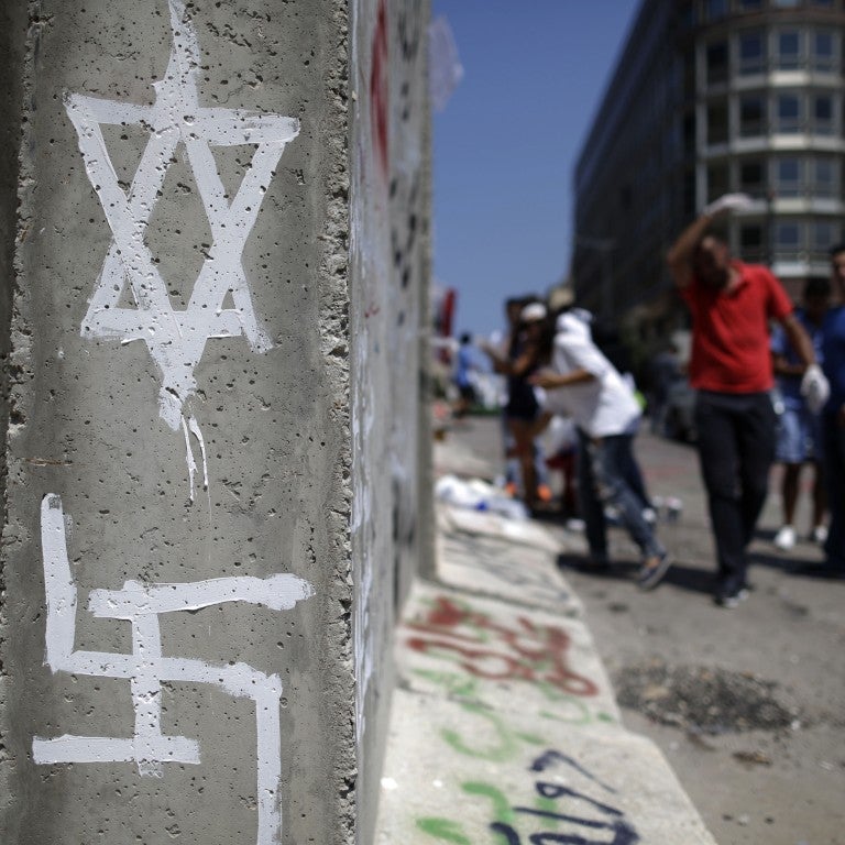 Photo of graffiti of a Star of David and a Swastika