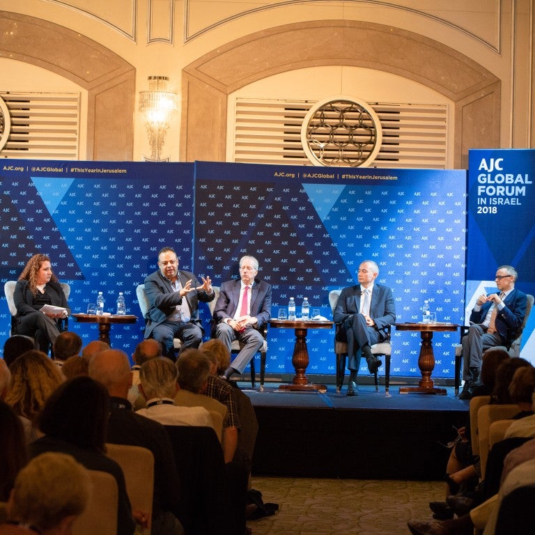 Photo of a panel of three leading officials from the EU, UN, and Israel, moderated by Melanie Maron Pell at AJC Global Forum 2018