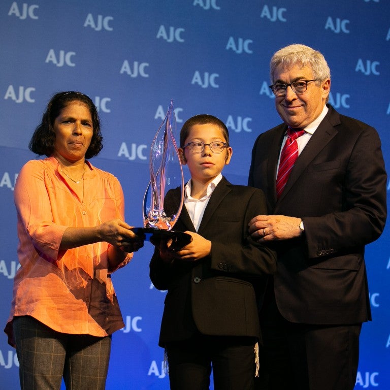 Photo of Sandra Samuel receiving the AJC Moral Courage Award with Former-AJC President Stanley M. Bergman and Moshe Holtzberg