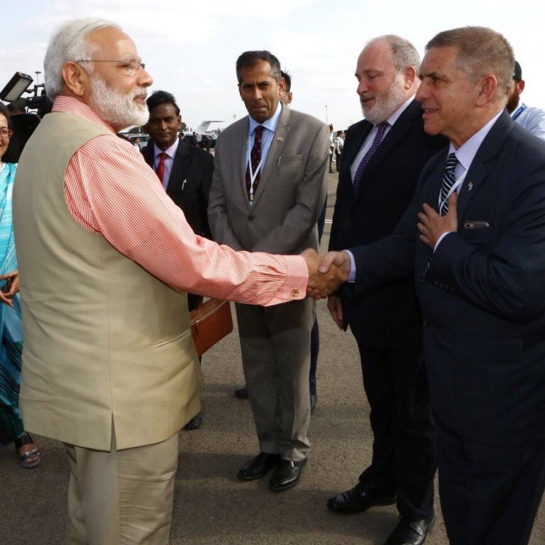 Photo of Indian Prime Minister Modi shaking hands with Israeli Ambassador Carmon