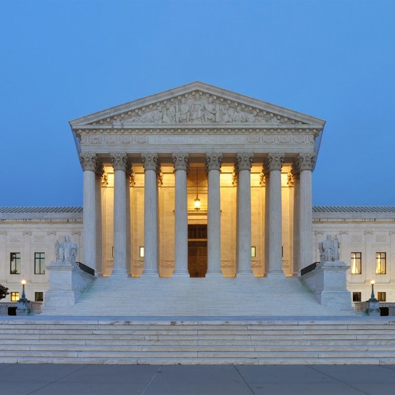 Photo of the Supreme Court at dusk