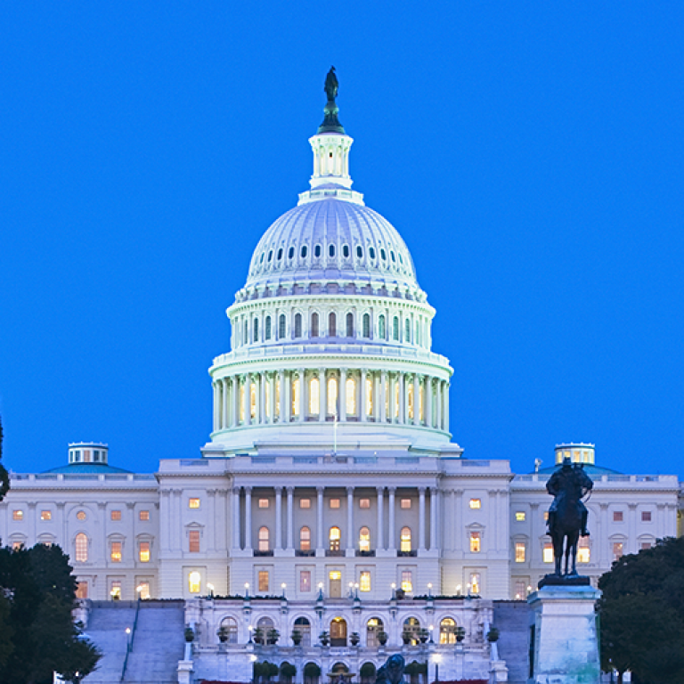 Photo of U.S. Capitol at night with AJC Global Forum 2019 text