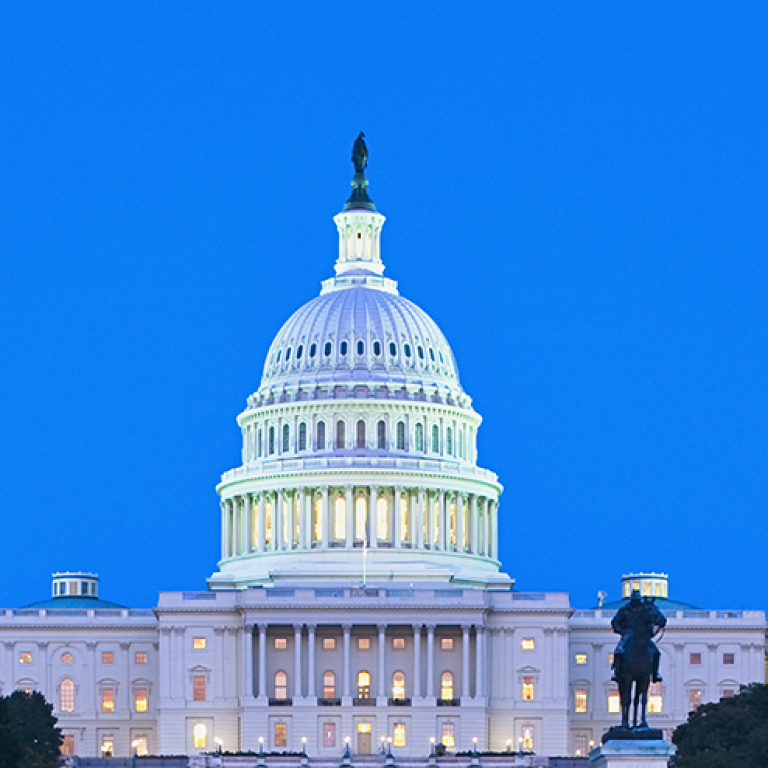 Photo of U.S. Capitol at night with AJC Global Forum 2019 text
