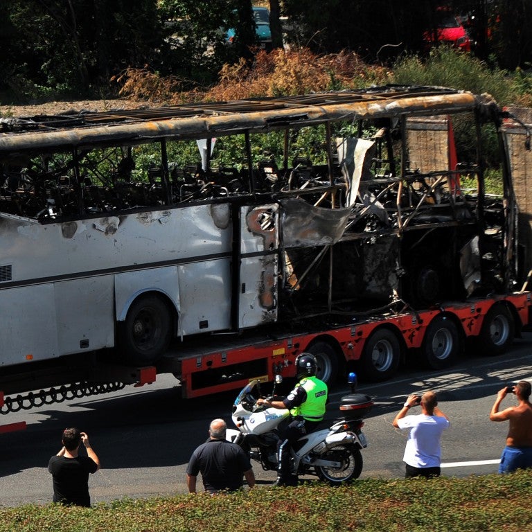 A truck carries the bus damaged by the suicide bomb blast which targeted a group of Israeli tourists at the airport in Bourgas, Bulgaria, on July 19, 2012.