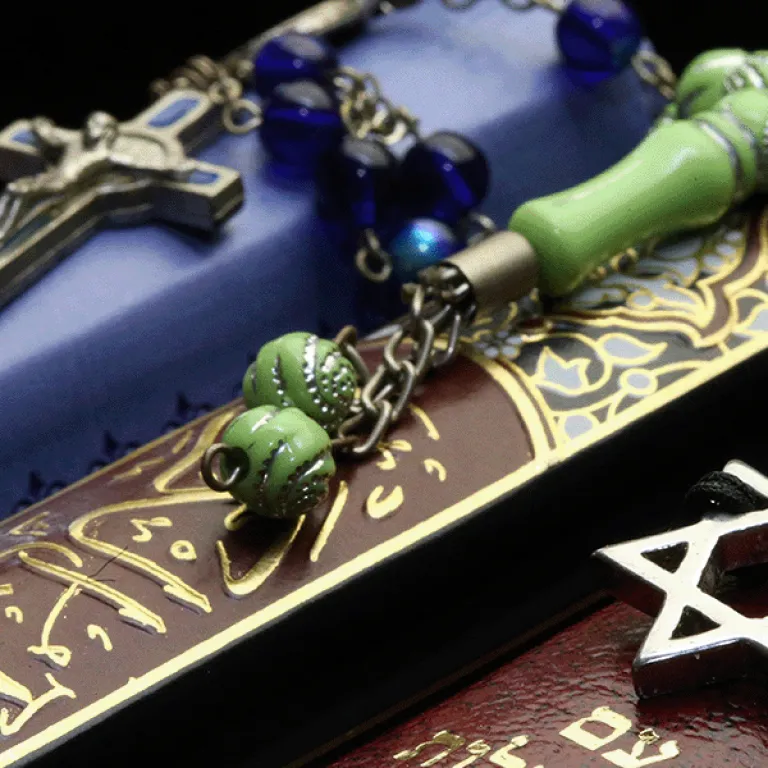 Photo of Bibles and Quran, interfaith symbols of Christianity, Islam and Judaism, the three monotheistic religions