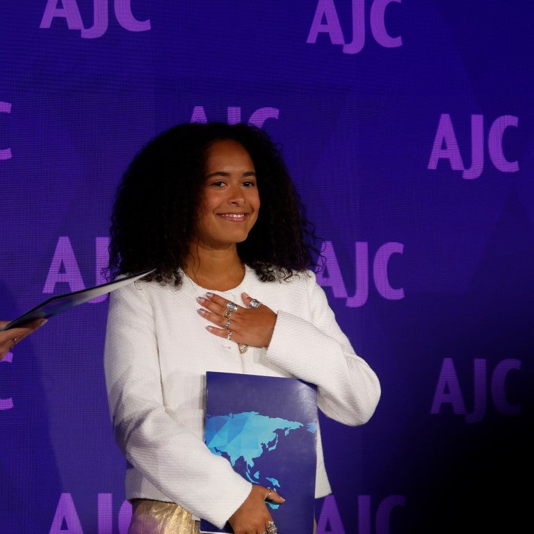 Image of Noa Fay accepting AJC's Sharon Greene Award for Campus Advocacy at AJC's 2024 Global Forum