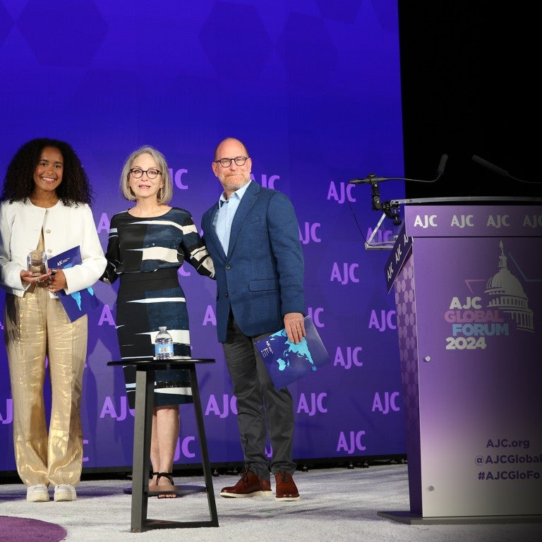 Image of Bill, Susan, and Josh Greene presenting the AJC Sharon Greene Award for Campus Advocacy to Hannah Veiler and Noa Fay at AJC's 2024 Global Forum