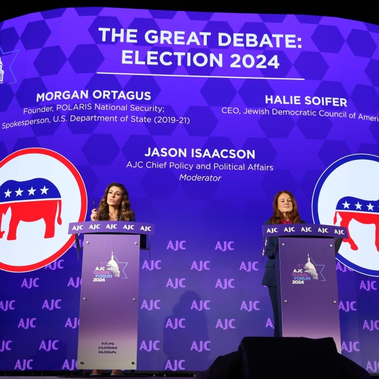 Photo of Morgan Ortagus and Halie Soifer at AJC Global Forum behind podiums for The Great Debate: Election 2024