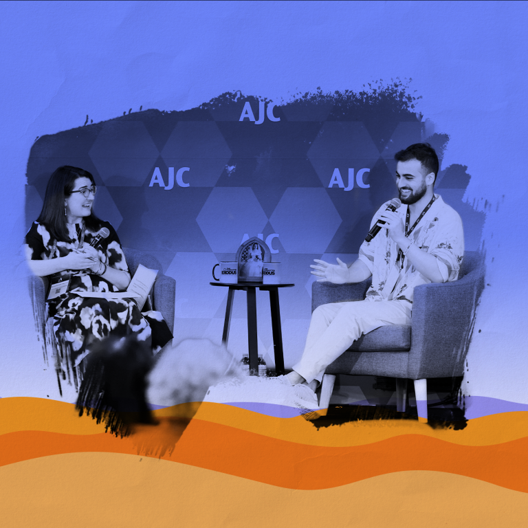 Photo of Adiel Cohen and Manya Brachear Pashman, both smiling and sitting in armchairs with a small endtable in the middle, on a stage in front of a step and repeat with AJC lettering, paintbrush effect around the photo, laid over a graphic representation of the desert