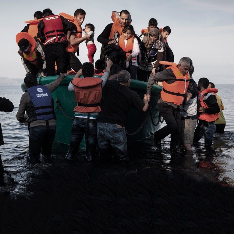 Photo of Refugees from Afghanistan and Syria arriving in a boat