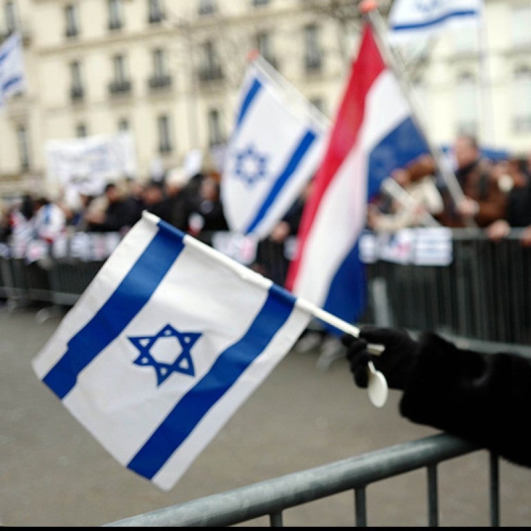 Photo of people waving Israeli and French flags