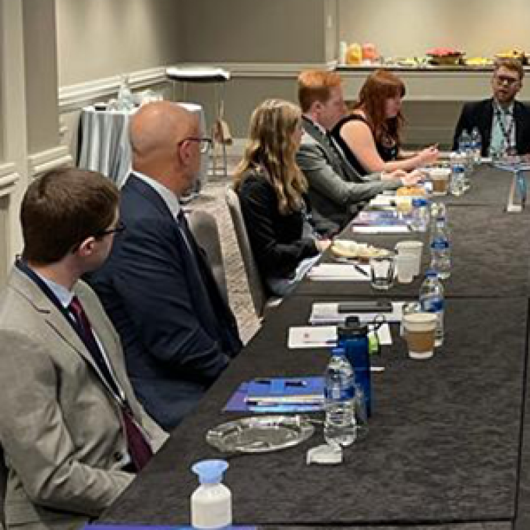 Photo of AJC's Campus Global Board sitting around the table with AJC CEO Ted Deutch