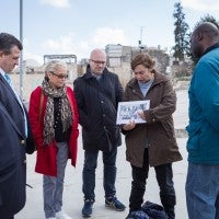 A Project Interchange delegation looking at a book